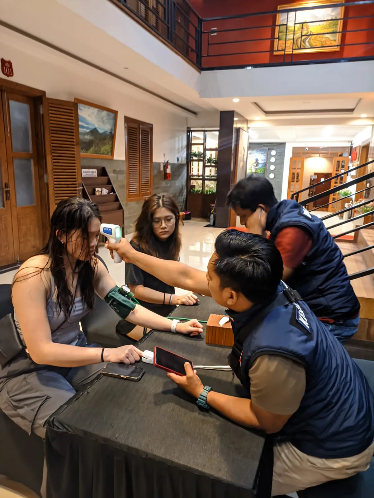 Nurse performing medical check at hotel